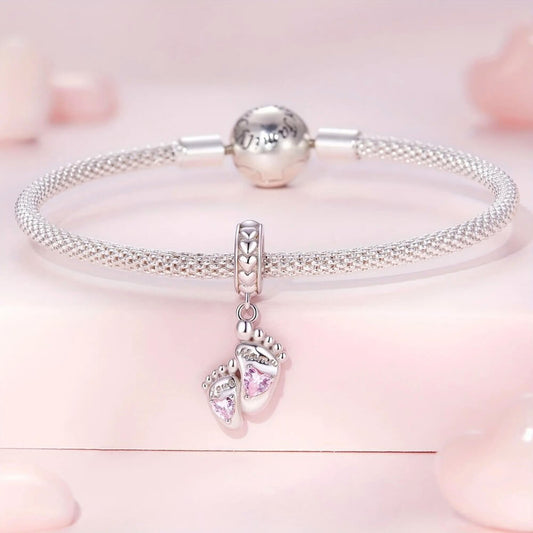 Sterling silver baby feet charm with pink heart crystals and mom engraving.