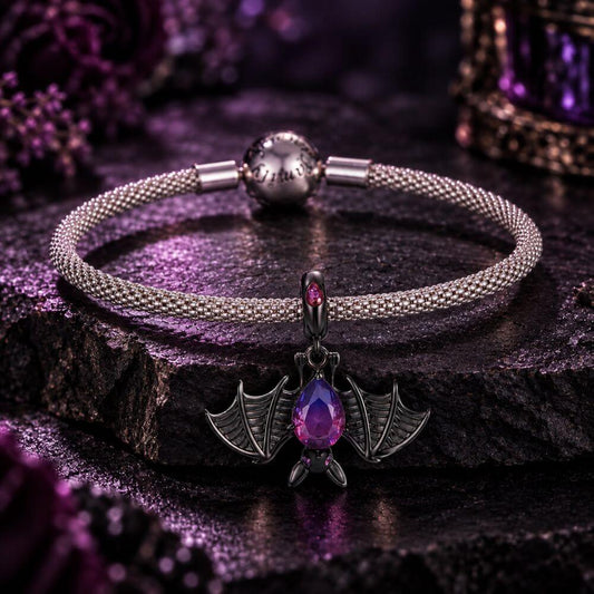 Black bat charm with purple blue crystal body, wide skeletal wings, and dark gothic Halloween details.