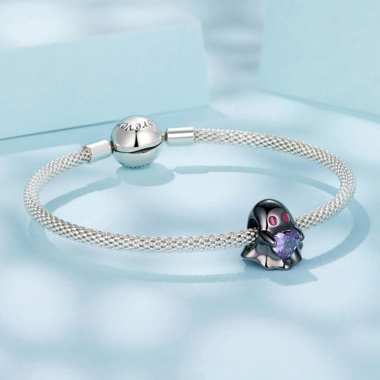 Black ghost charm holding purple heart crystal in sterling silver style.