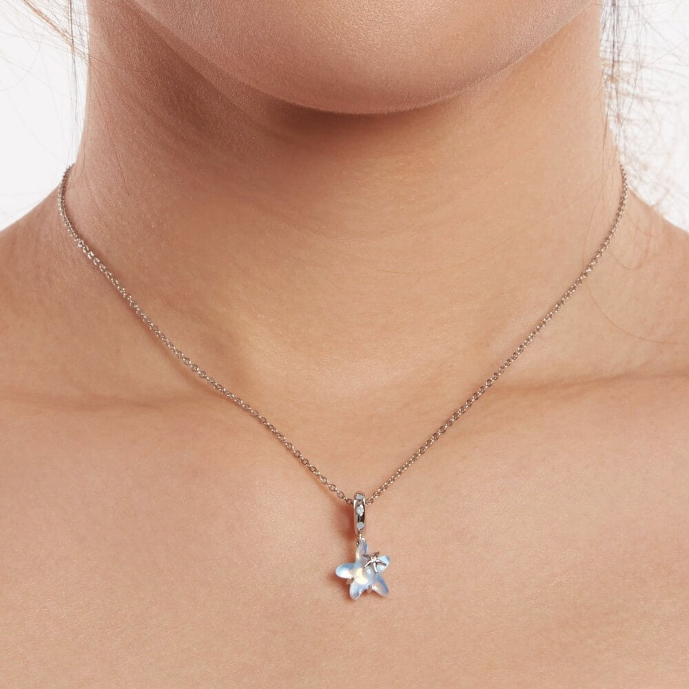 Sterling silver starfish charm with blue opalescent enamel and crystal detail.
