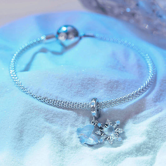 Sterling silver double dangle charm with opal-like butterfly, snowflake, and light blue accents.