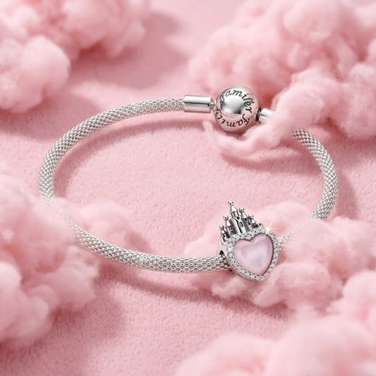 Sterling silver castle charm with pink heart center and crystal border.