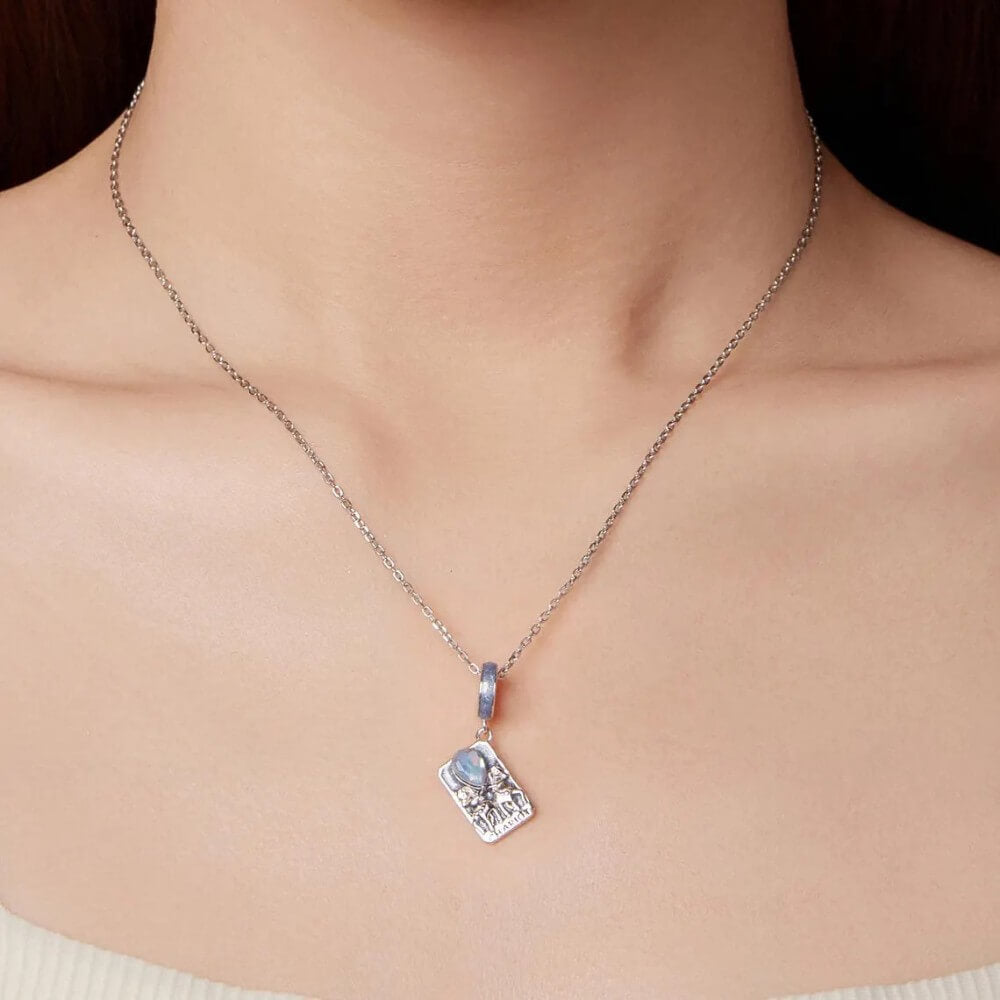 Sterling silver tarot card charm with horses, blue enamel, and opal crystal.