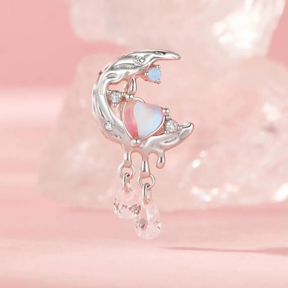 Sterling silver crescent moon charm with opal heart, clear gemstones, and dangling crystals.