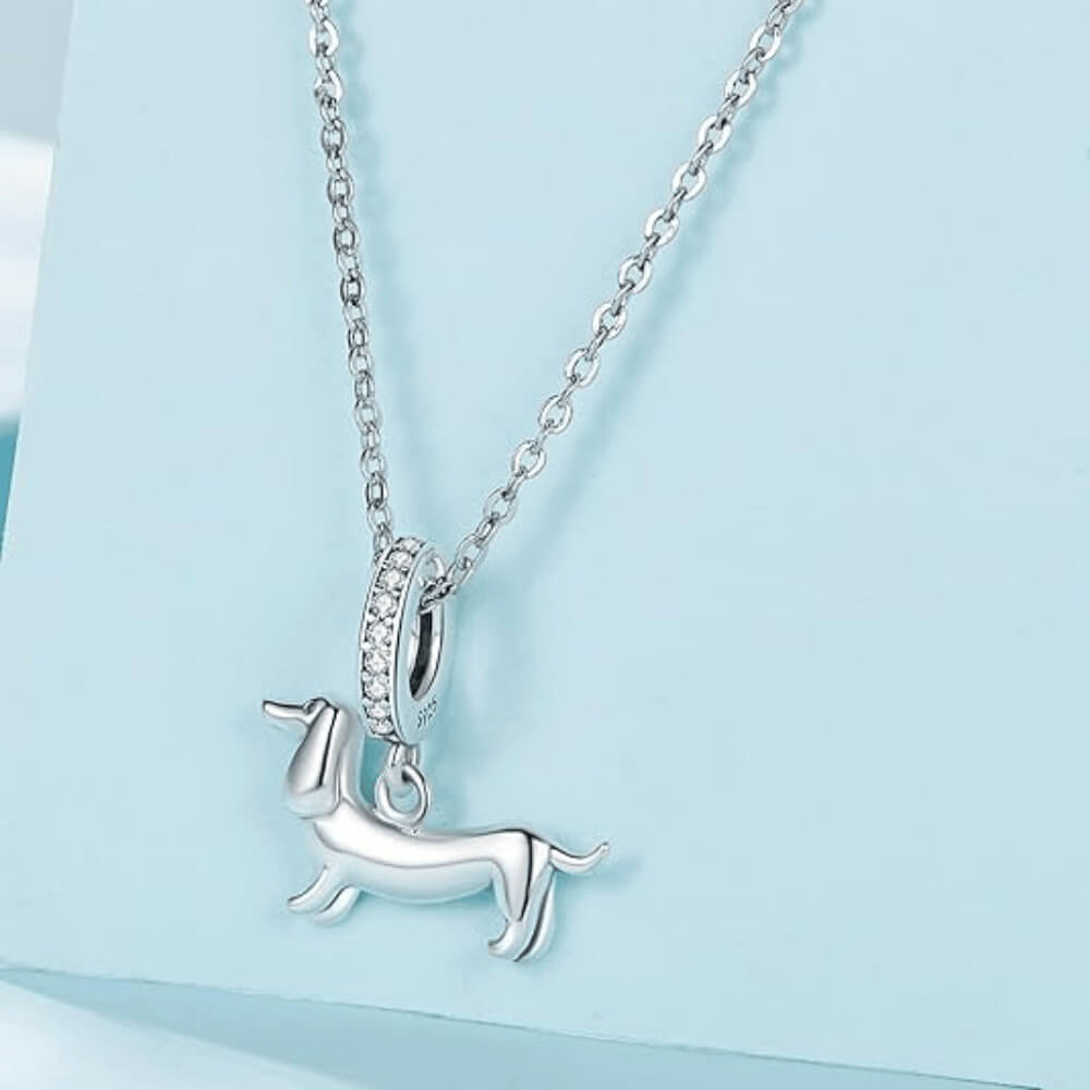 Sterling silver dachshund charm with long body and crystal-studded bail