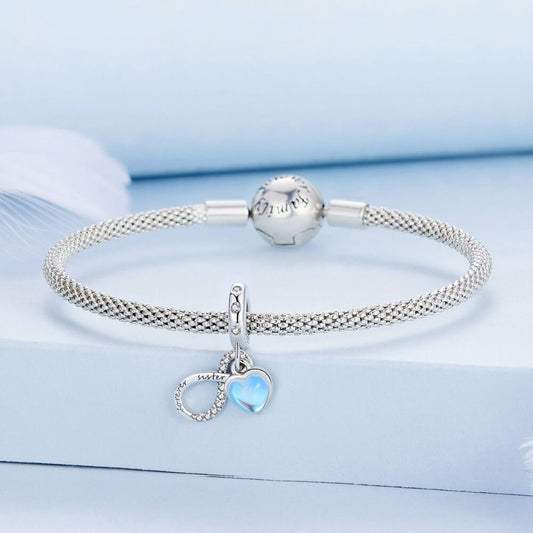 Sterling silver forever sister charm with blue heart and crystal infinity detail.