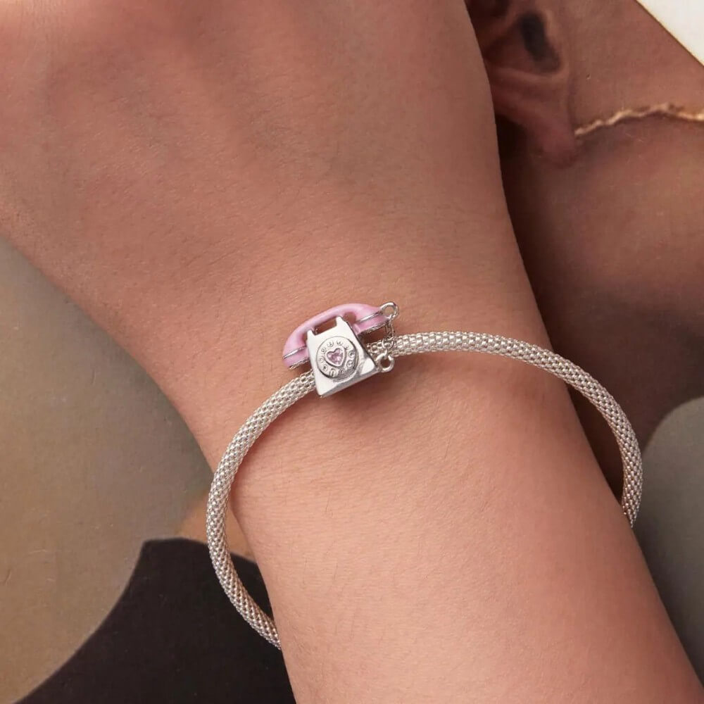 Sterling silver phone charm with heart detail and polished finish.