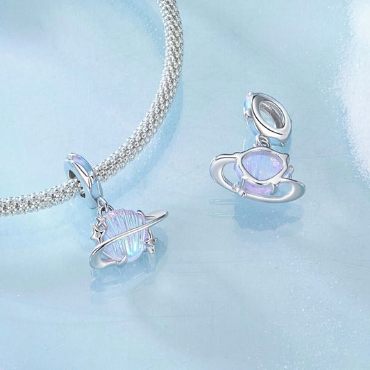Sterling silver planet charm with iridescent shell design and star accents.