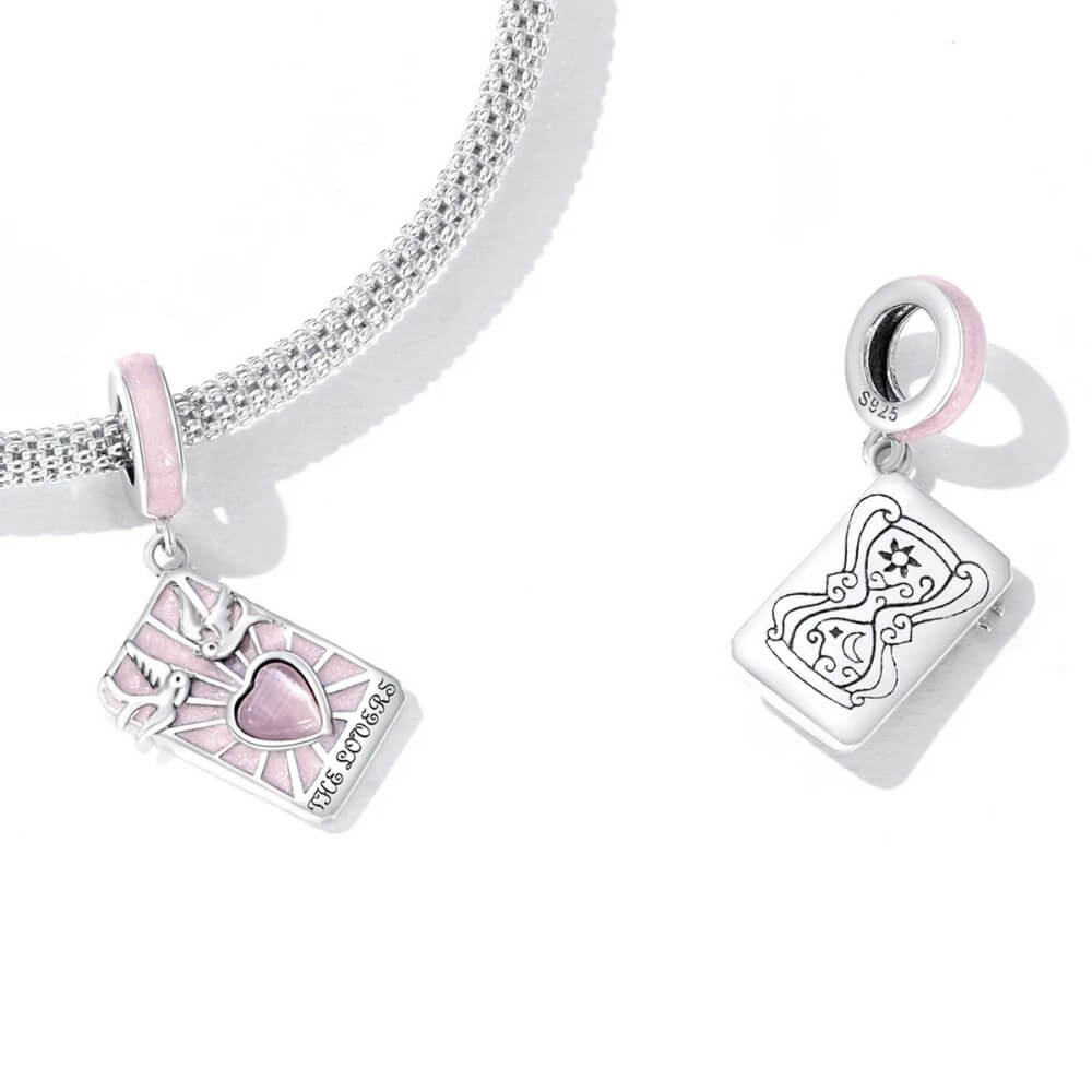 Sterling silver lovers promise charm with pink heart, doves, and engraved message.