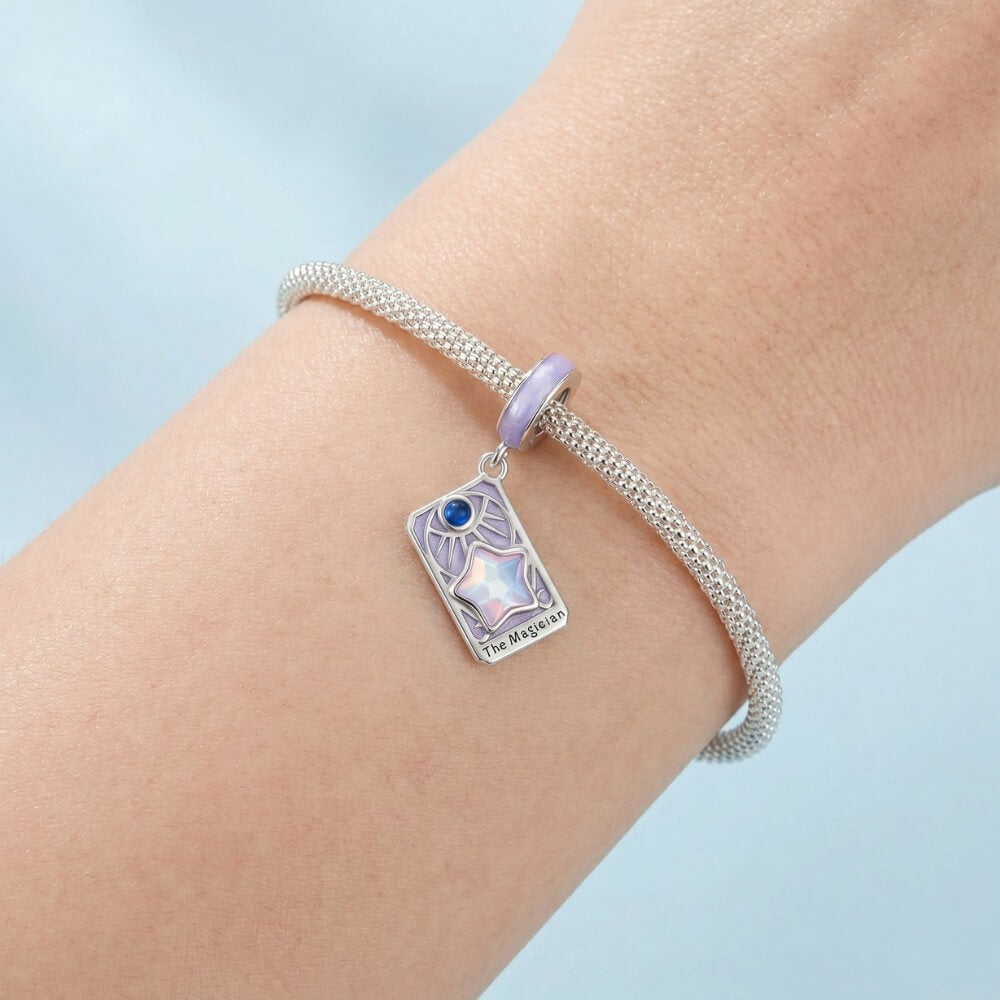 Sterling silver magician tarot charm with lavender enamel and iridescent star.