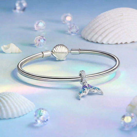 Sterling silver mermaid tail charm with blue purple enamel and crystal details.