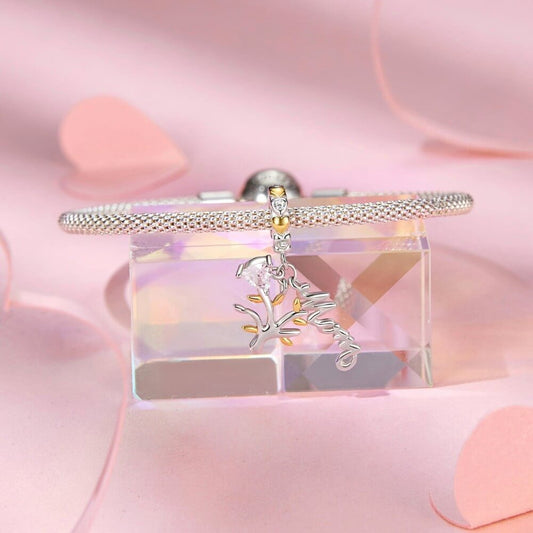 Sterling silver family tree charm with mom script and heart crystal.