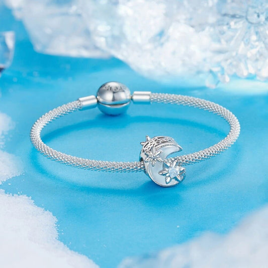 Sterling silver moon charm with iridescent enamel and floral crystal details.