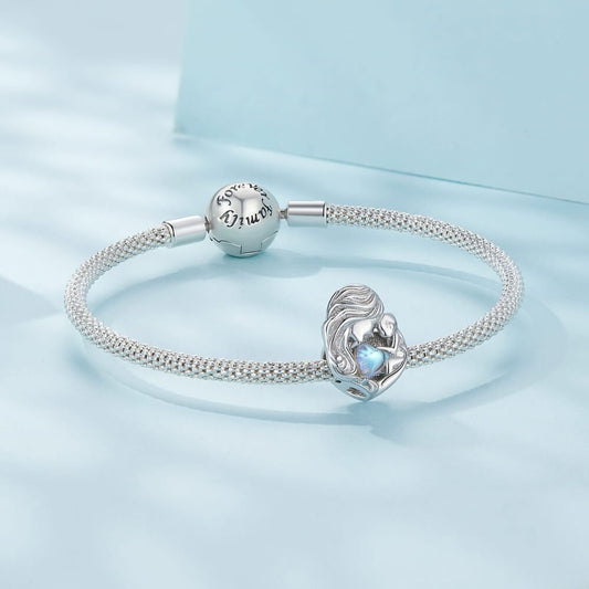 Sterling silver mother and baby charm with iridescent heart detail.