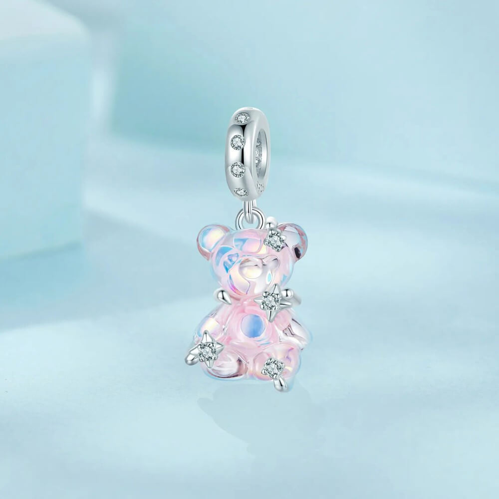 Sterling silver teddy bear charm with pink opalescent glass and crystal accents.