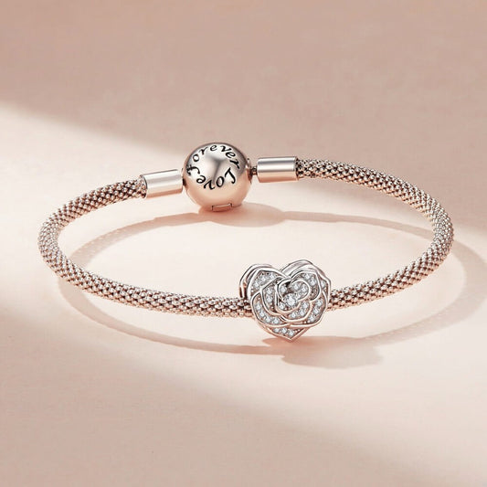 Silver bracelet with heart-shaped charm on a beige background