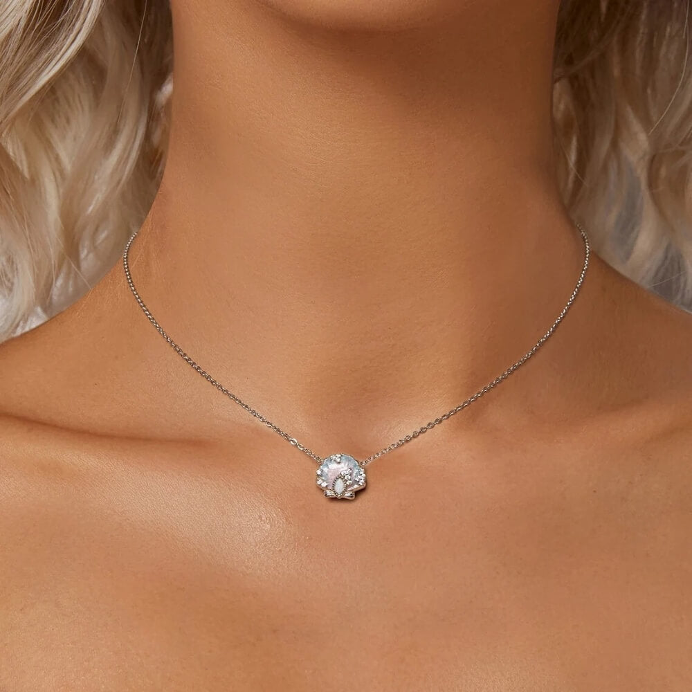 Sterling silver seashell charm with pastel enamel and crystal accents.