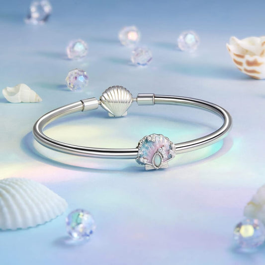 Sterling silver seashell charm with pastel enamel and crystal accents.
