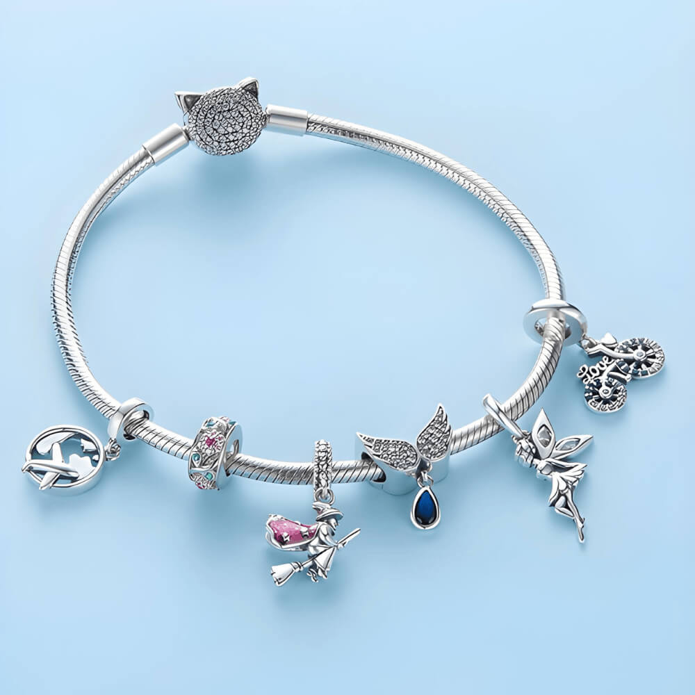 Sterling silver charm with a globe outline and a small airplane dangle in front