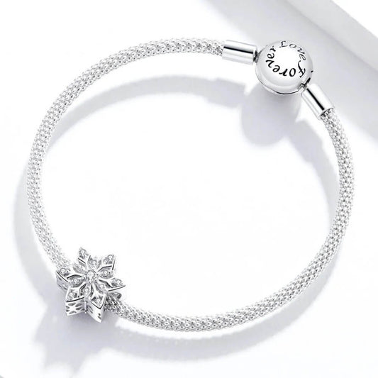 Sterling silver snowflake charm with clear crystal stones.