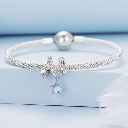 Sterling silver swirl charm with star details and iridescent dangling crystal.