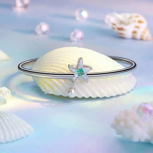 Sterling silver starfish charm with green crystal, opal stones, and pearl.