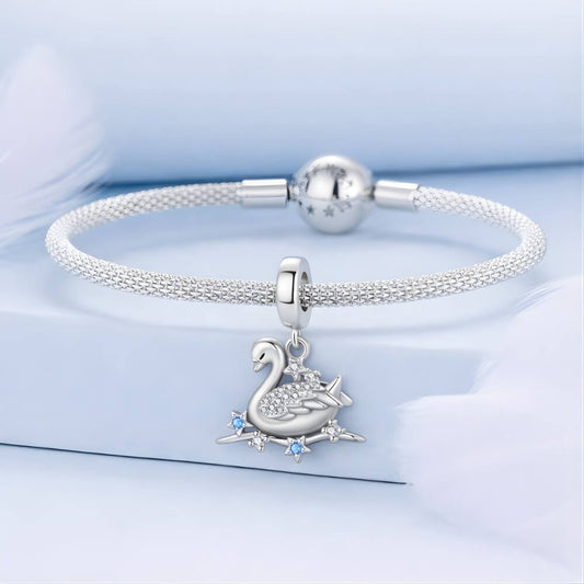 Sterling silver swan charm with crystal wings and star accents.