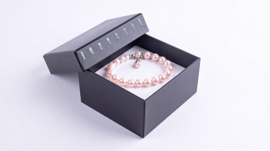 Pearl bracelet displayed inside an open black jewelry gift box