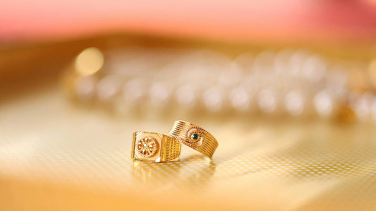 Two gold rings placed on a patterned surface