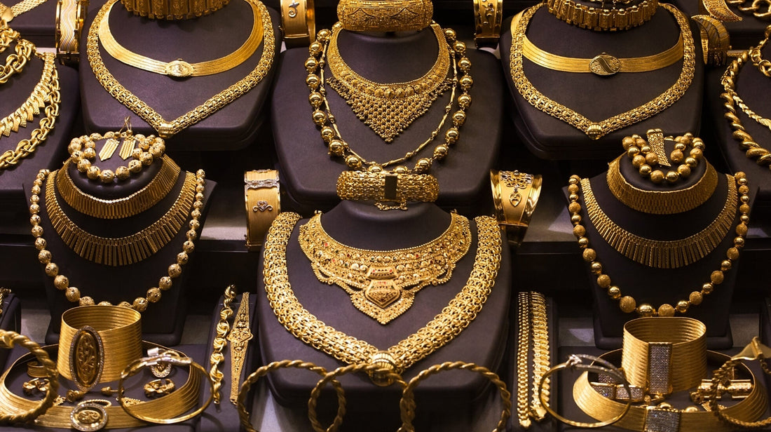 Display of ornate gold necklaces and bracelets showcasing famous historical jewelry designs
