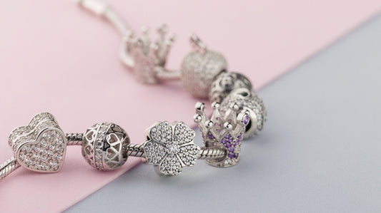 Charm bracelet with symbolic silver charms representing meaningful gifts during life transitions