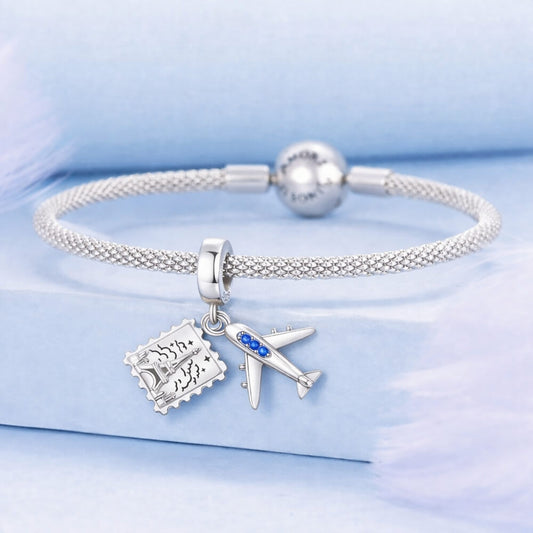 Sterling silver airplane and postcard charm with blue crystal accents.