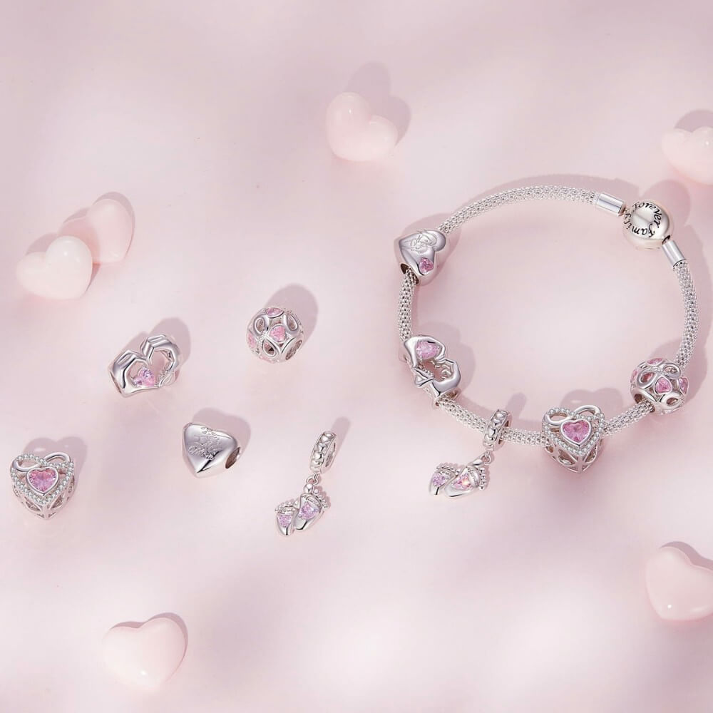 Sterling silver baby feet charm with pink heart crystals and mom engraving.