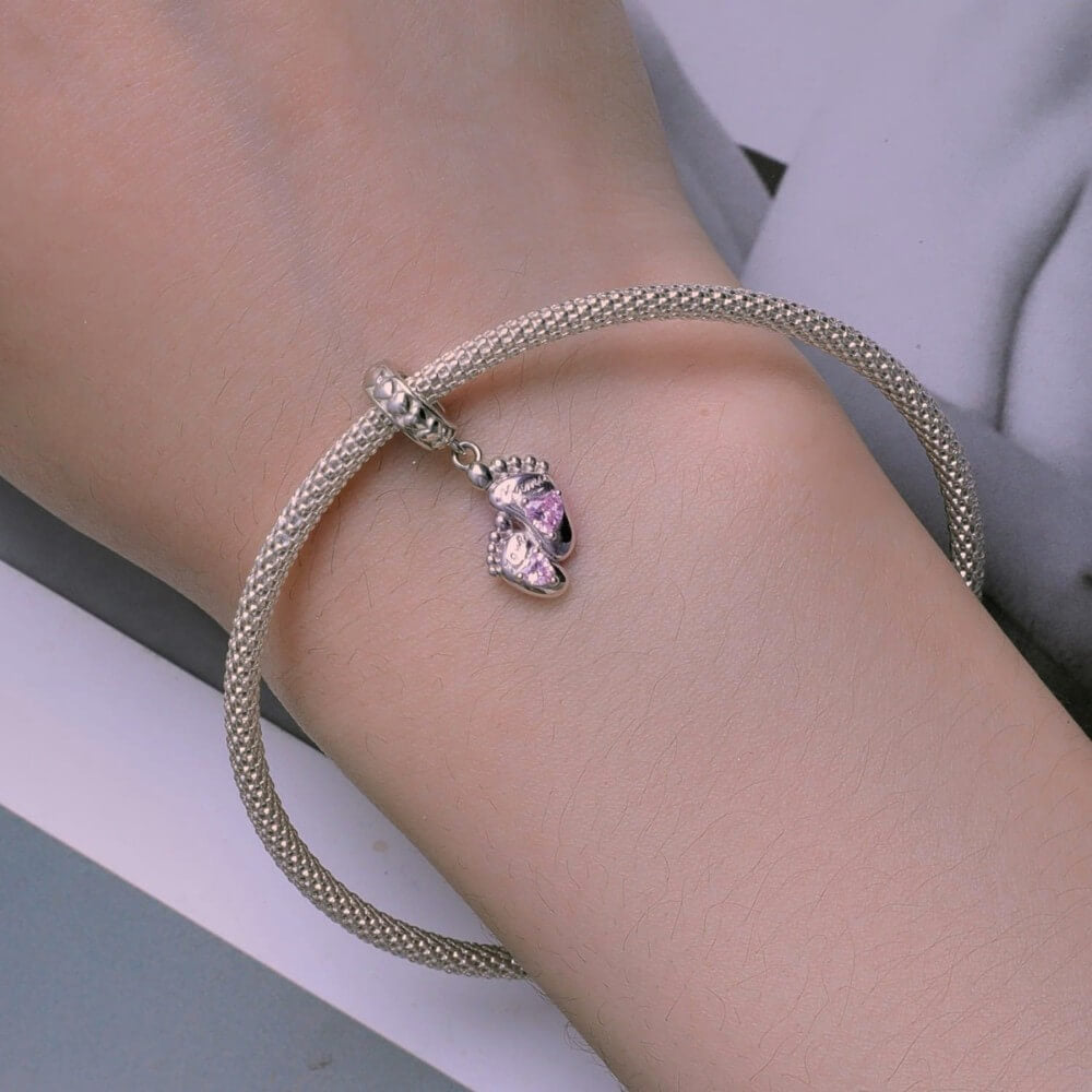 Sterling silver baby feet charm with pink heart crystals and mom engraving.