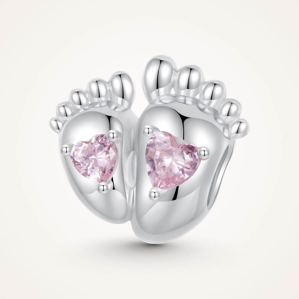 Sterling silver baby feet charm with two pink heart crystals and polished newborn footprint details - ORÉYA