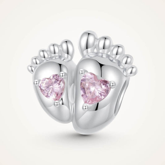 Sterling silver baby feet charm with two pink heart crystals and polished newborn footprint details - ORÉYA