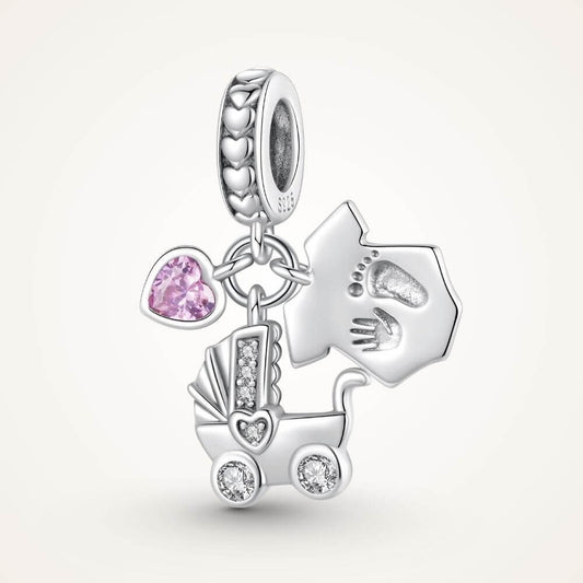 Sterling silver baby charm with stroller, pink heart crystal, house tag, and tiny hand and footprint details - ORÉYA