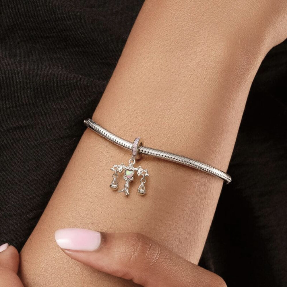 Sterling silver balance charm with opal heart center and hanging scales.