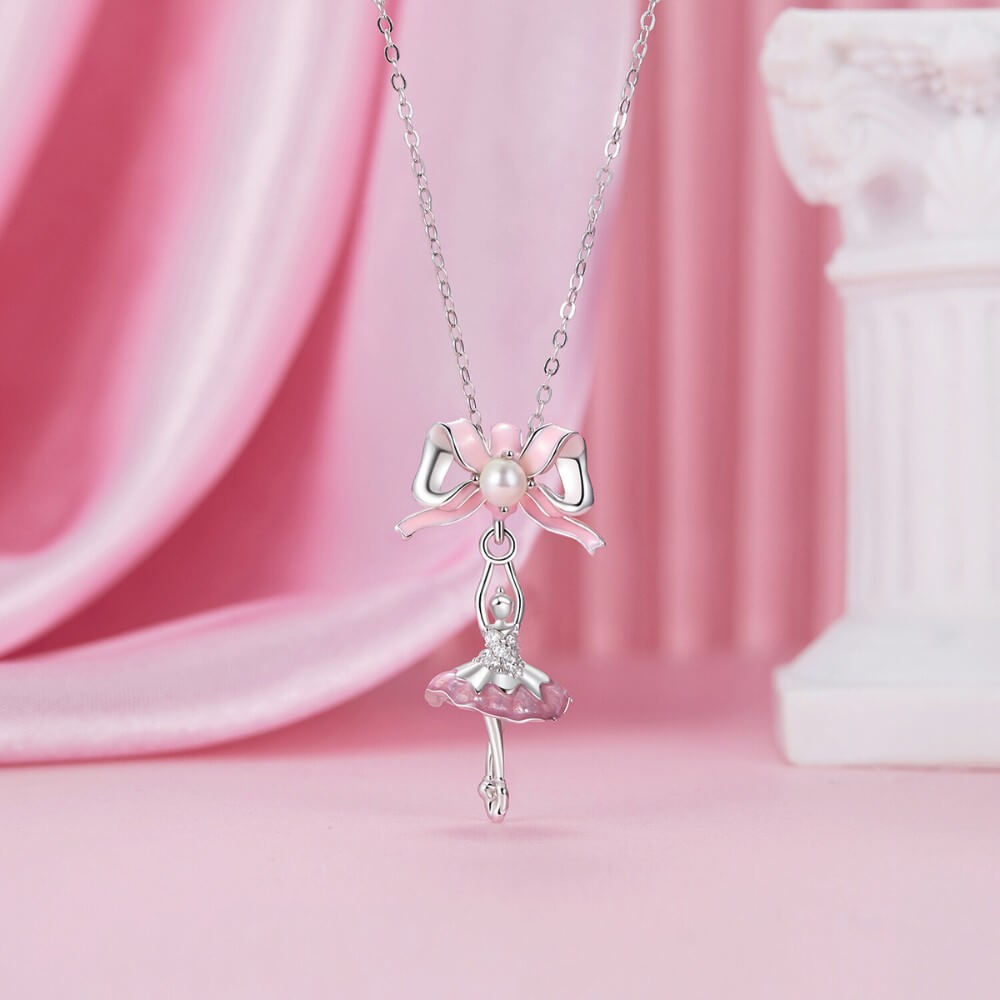 Sterling silver ballerina charm with pink enamel bow and crystal accents.