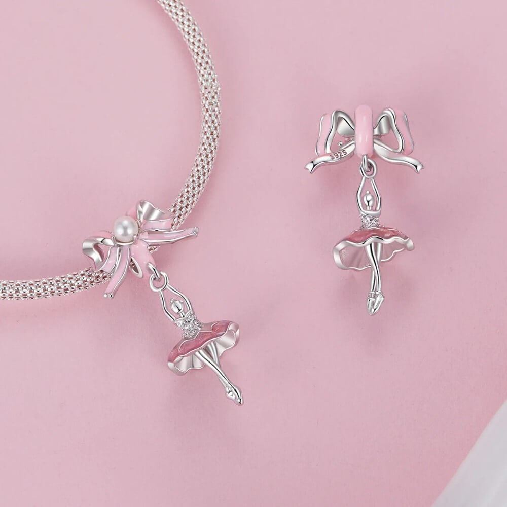 Sterling silver ballerina charm with pink enamel bow and crystal accents.