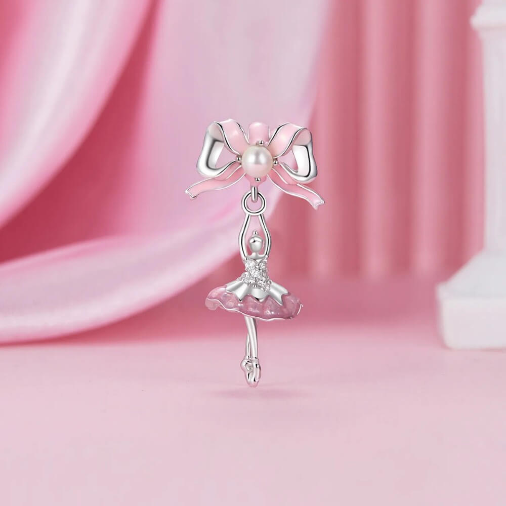 Sterling silver ballerina charm with pink enamel bow and crystal accents.
