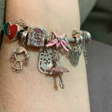 Sterling silver ballerina charm with pink enamel bow and crystal accents.
