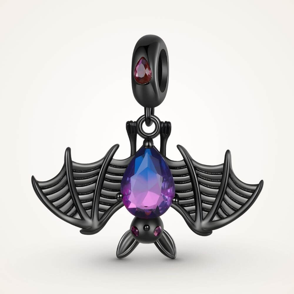 Black bat charm with purple blue crystal body, wide skeletal wings, and dark gothic Halloween details - ORÉYA