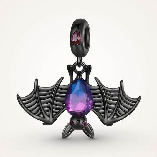Black bat charm with purple blue crystal body, wide skeletal wings, and dark gothic Halloween details - ORÉYA