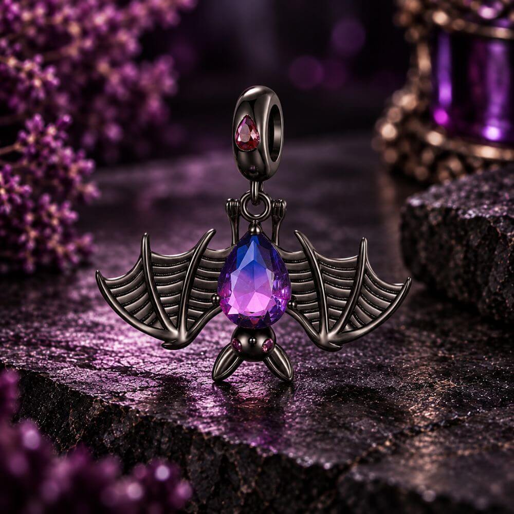 Black bat charm with purple blue crystal body, wide skeletal wings, and dark gothic Halloween details.
