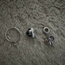 Sterling silver heart charm with black enamel flame design.