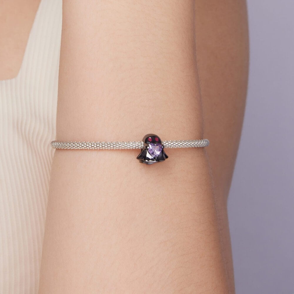 Black ghost charm holding purple heart crystal in sterling silver style.