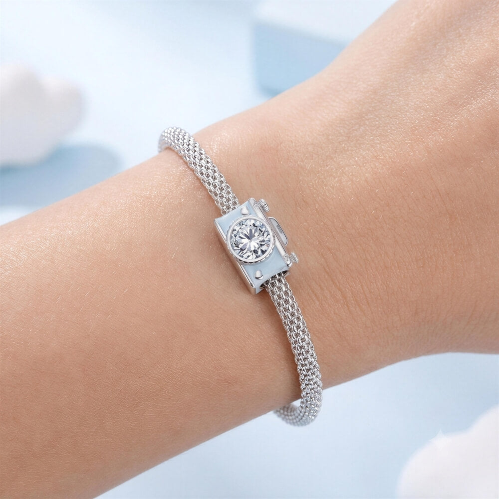 Sterling silver camera charm with blue enamel, heart details, and crystal lens.