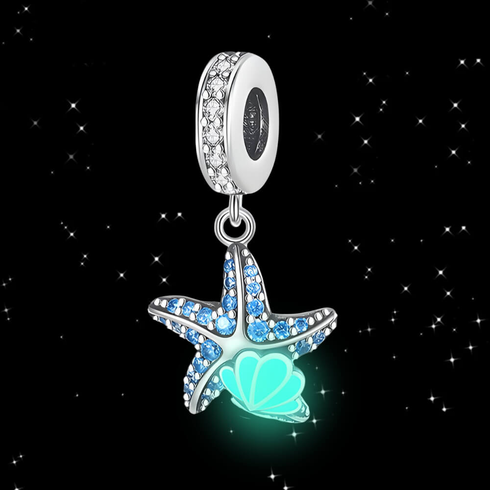 Sterling silver starfish charm with blue gemstones and teal enamel shell detail.