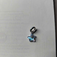 Sterling silver starfish charm with blue opalescent enamel and crystal detail.